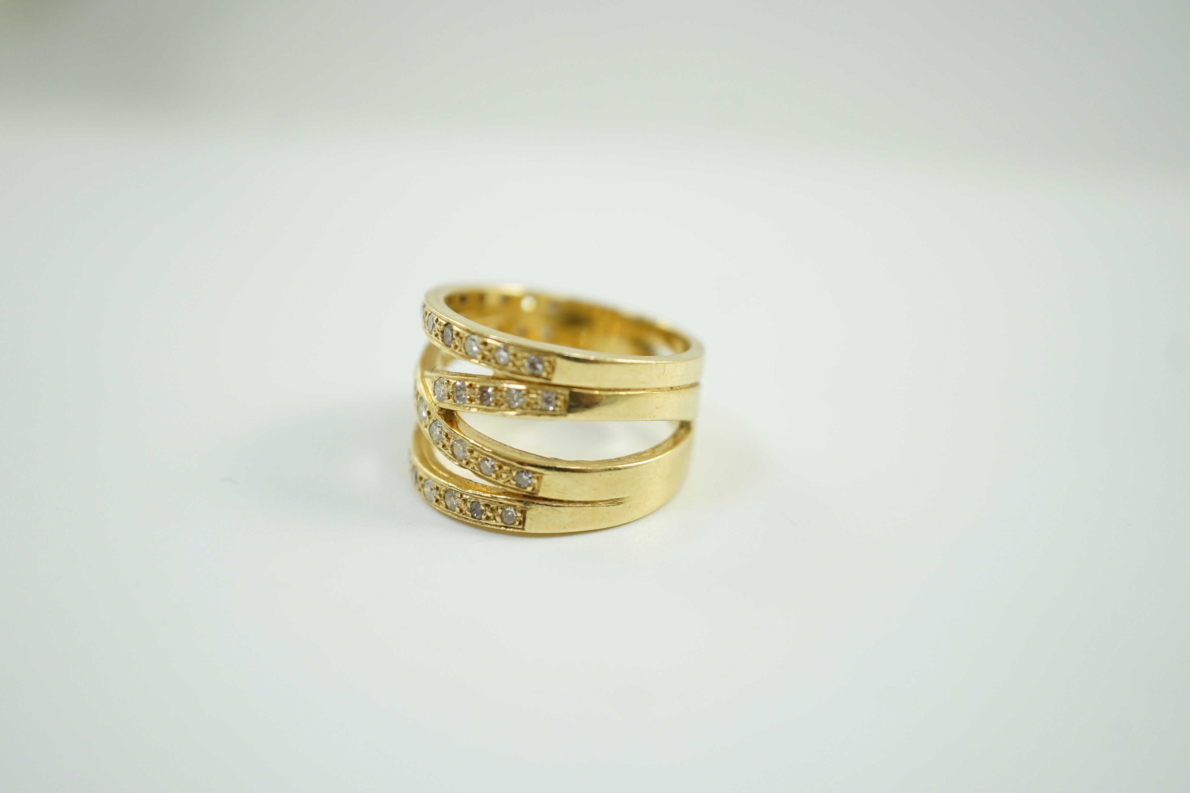 A modern 750 and diamond chip cluster set multi shank dress ring, size P, gross 10.1 grams.